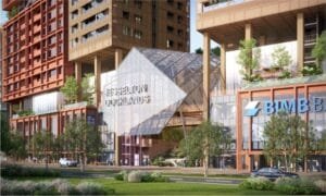 Grand entrance of The Bedrock Sabah at Jesselton Docklands with modern glass façade and landscaped surroundings.