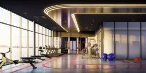 Modern gym facility at The Lighthauz with full-height windows and sea-facing exercise area.