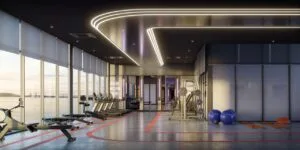 Indoor fitness zone at The Lighthauz with cardio machines, weights and bright window views.