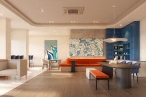 Relaxing indoor lounge at The Lighthauz with warm seating, blue shelving and modern coastal-inspired interior design.