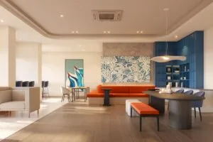 Relaxing indoor lounge at The Lighthauz with warm seating, blue shelving and modern coastal-inspired interior design.