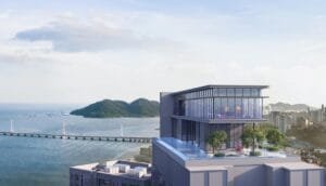 Rooftop facilities deck at The Lighthauz with elevated pool area, landscaped spaces and wide coastal scenery.