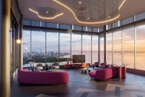 Spacious sky lounge at The Lighthauz with full-height glass windows overlooking Penang’s coastal view.