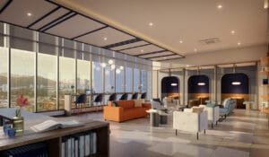 Co-working lounge at Keeperz Suites with study pods, lounge seating and bright city-facing windows.