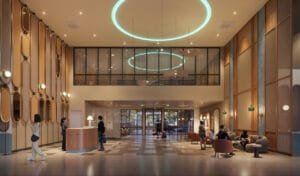 Modern lobby area at Keeperz Suites with warm lighting, lounge seating and double-volume arrival space.