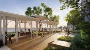 Outdoor pavilion grillbar at Keeperz Suites with dining spaces, landscaped deck and waterfront view.